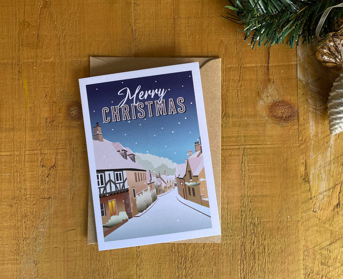 Castle Combe retro Christmas card on table