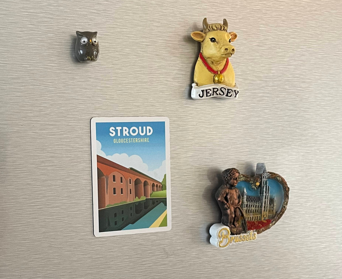 Stroud magnet on fridge with other travel magnets