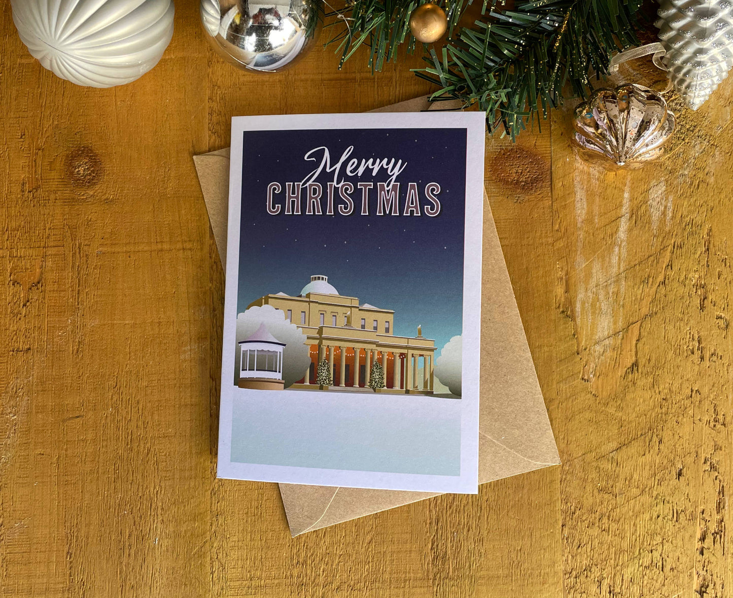 Cheltenham Christmas Card on table with decorations