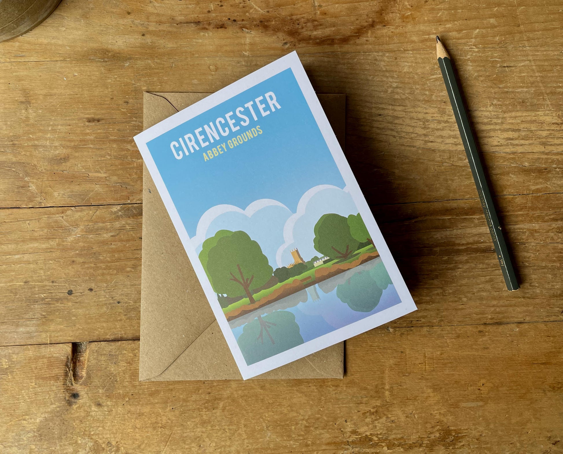 Cirencester Abbey Grounds Greeting Card on a desk